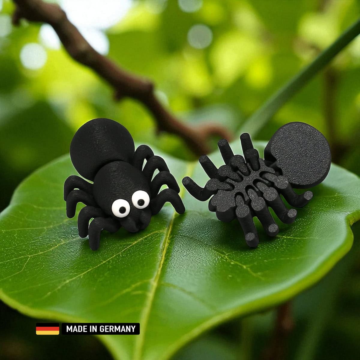 schwarze kabbelspinne mit wackel beinen, dekoration mehrfarbig